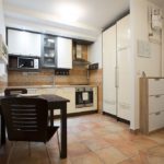 Fully equipped modern kitchen with dining table.