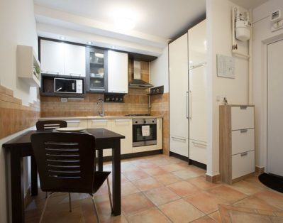 Fully equipped modern kitchen with dining table.