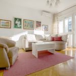 Living room with double sofa bed, armchair and exit to the sunny terrace.