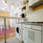 Fully equipped kitchen with washing machine.