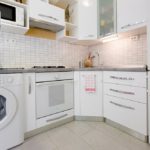 Fully equipped kitchen with washing machine.