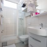 Bathroom with shower, toilet and sink.