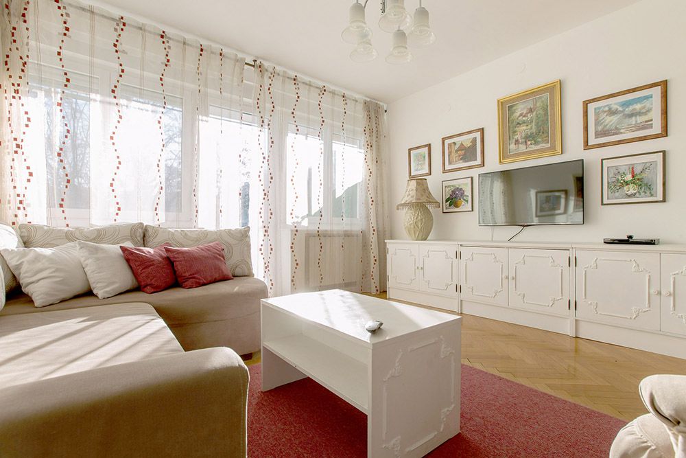 Living room with double sofa bed, smart TV and exit to the sunny terrace.