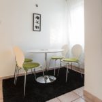 Dining area with round table for 5 persons.